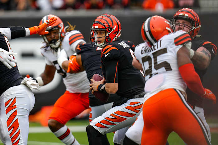 Cincinnati Bengals quarterback Joe Burrow (9) protects the ball in the pocket under pressure from Cleveland Browns defensive end Myles Garrett (95) in the second quarter of the NFL Week 14 game between the Cincinnati Bengals and the Cleveland Browns at Paycor Stadium in Cincinnati on Sunday, Dec. 11, 2022. The Bengals led 13-3 at halftime. Cleveland Browns At Cincinnati Bengals Week 14